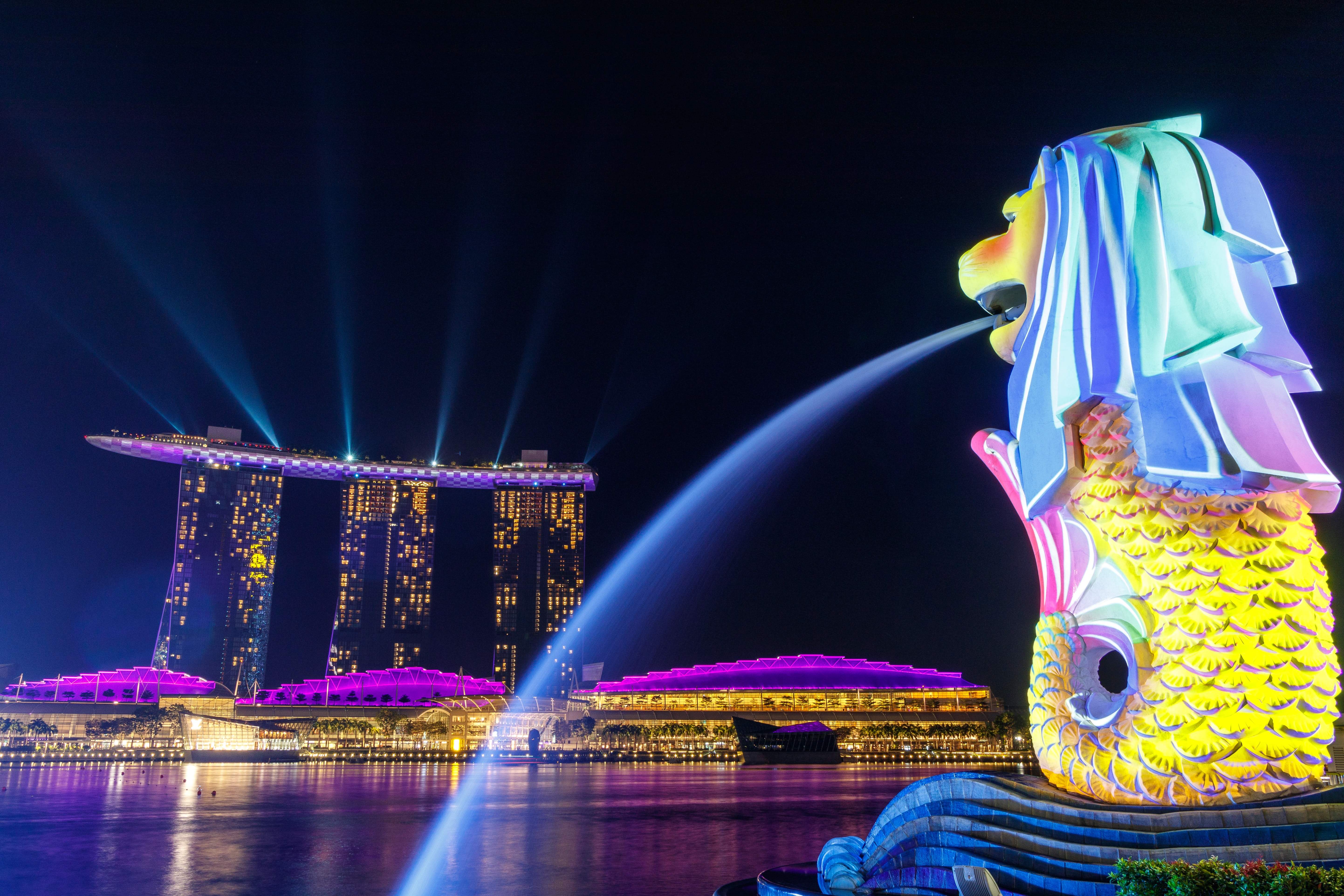 Lights Shone On The Merlion As It Overlooks Singapore's Iconic Marina Bay Sands